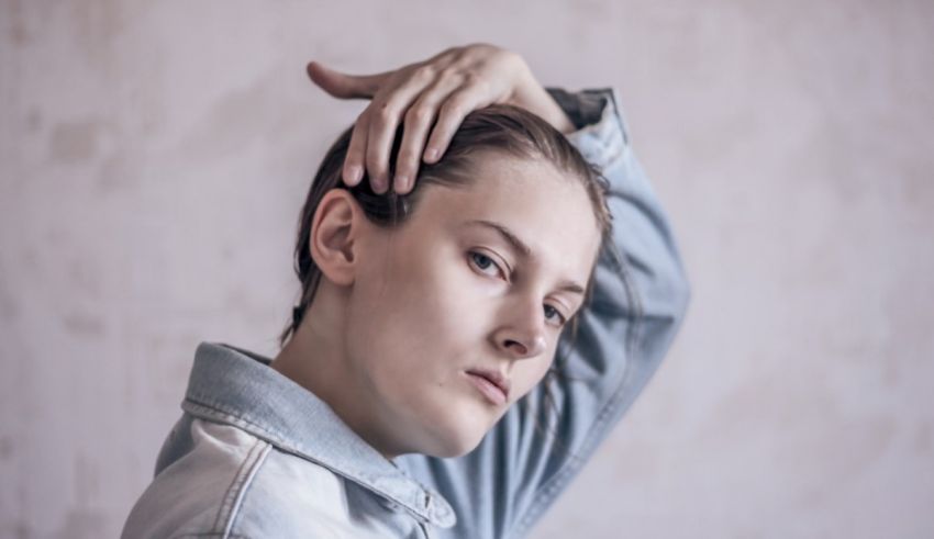 A woman with her hands on her head.