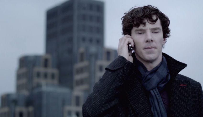 Sherlock holmes on a cell phone in front of a city.