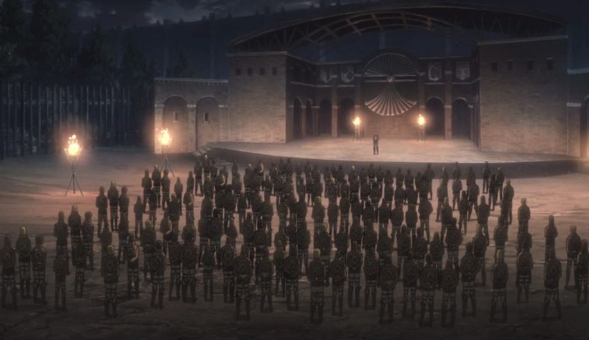 A large group of people standing in front of a stage.