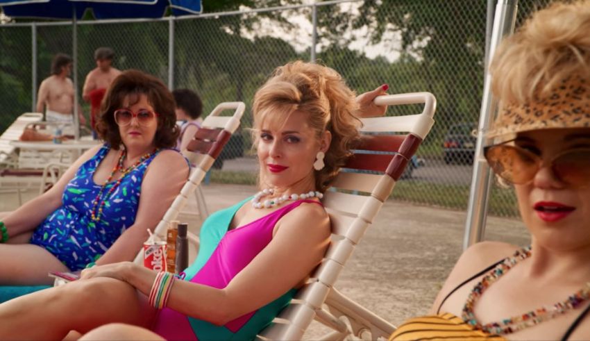 A group of women sitting in chairs at a pool.