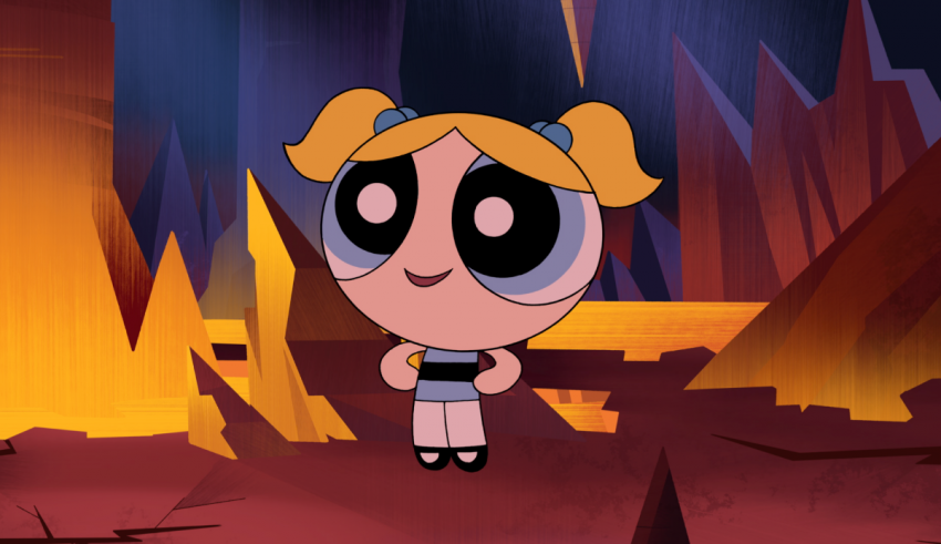 The powerpuff girl standing in front of a cave.