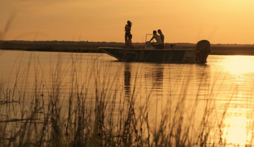 Two people on a boat at sunset.