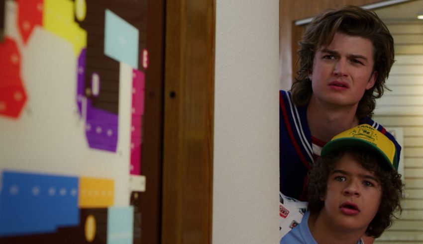 Two young men looking at each other in a hallway.