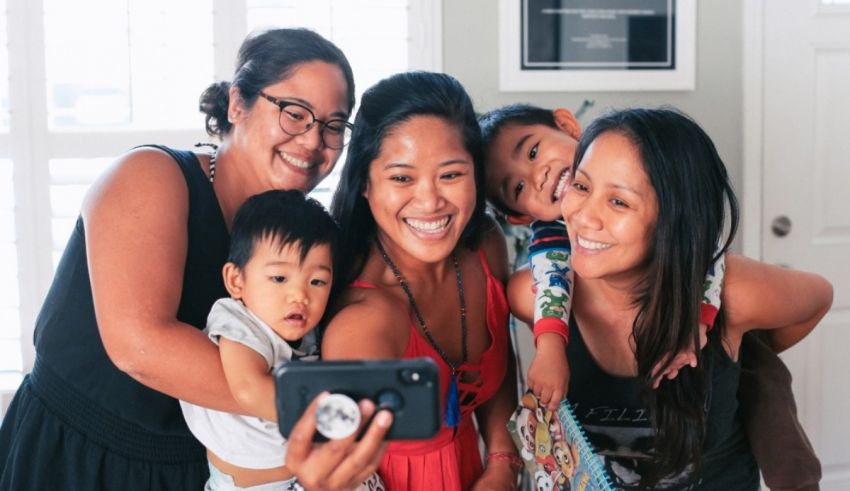 A family is taking a selfie with a cell phone.