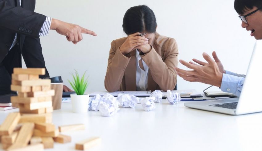 A group of asian business people arguing at a meeting.