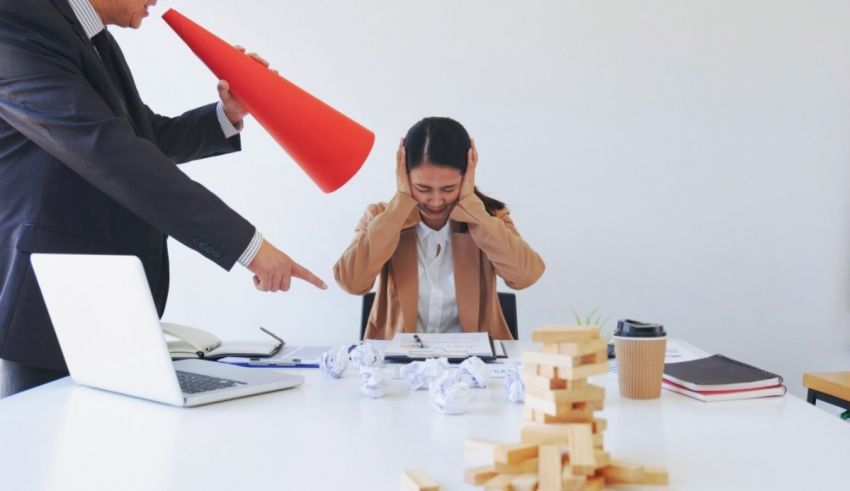 A man is yelling at a woman in an office.