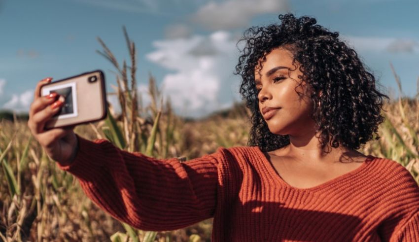 A woman taking a selfie in a corn field.