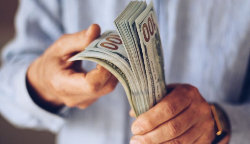 A man is holding a stack of money in his hands.