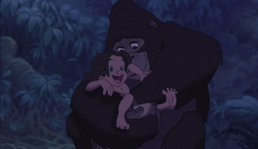 A gorilla is holding a child in the jungle.