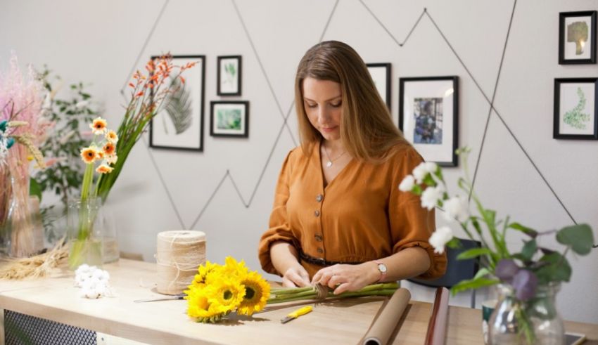 A woman is arranging flowers in a flower shop.