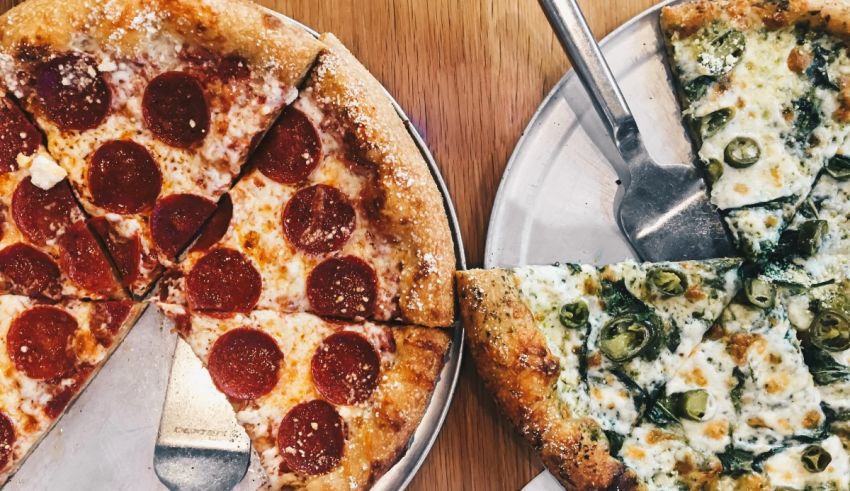 Two slices of pizza with pepperoni and peppers on a plate.