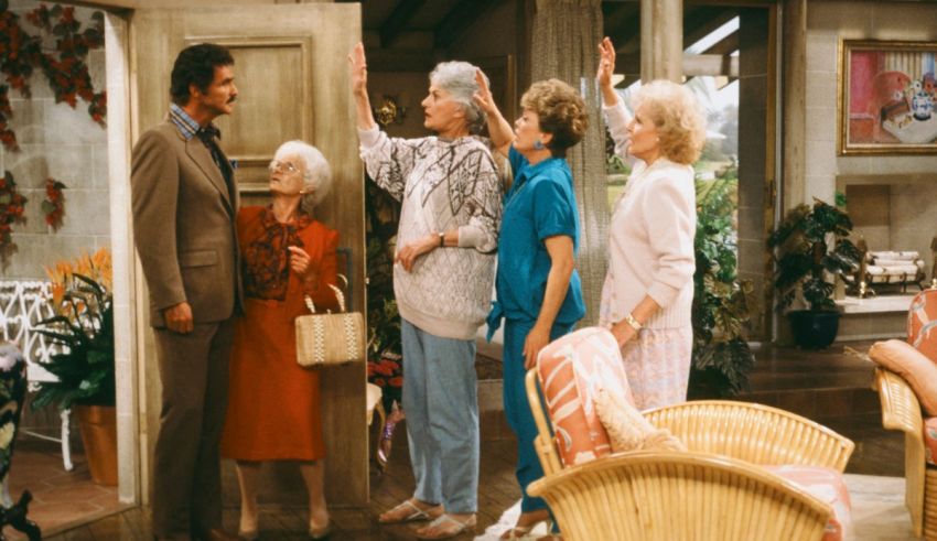 A group of people standing in a living room.