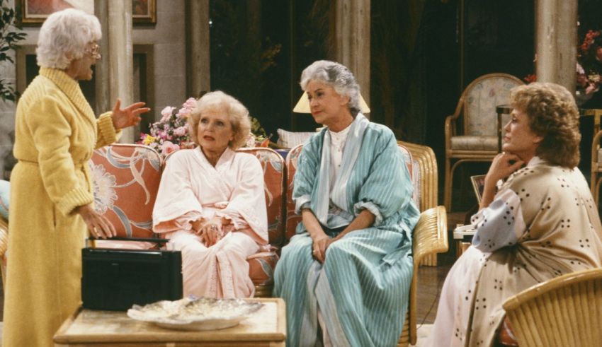 A group of women in robes sitting in a living room.