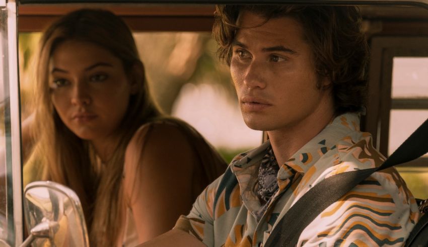 A man and woman sitting in the back seat of a car.