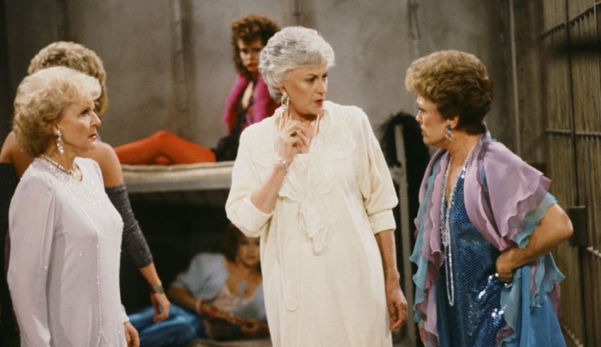 A group of older women standing in a jail cell.