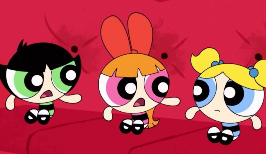 The powerpuff girls are sitting on a red couch.