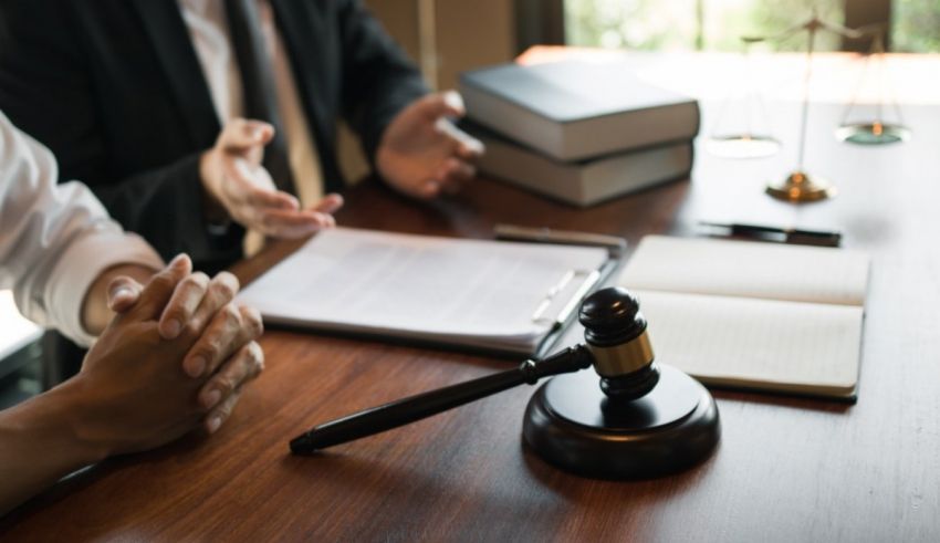 Two people sitting at a table with a gavel.