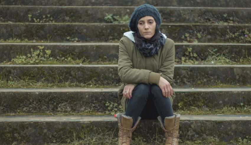 A woman sitting on the steps of a building.