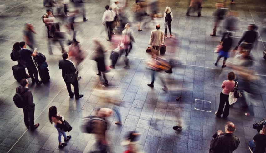 A blurry image of people walking in a busy area.