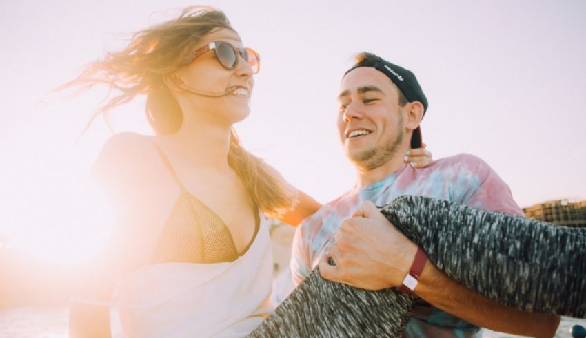 A man and woman are having a good time at the beach.