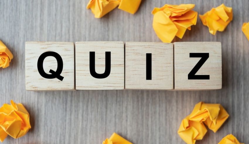 A wooden block with the word quiz surrounded by yellow paper.