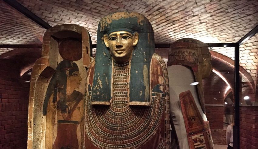 An egyptian sarcophagus is on display in a museum.