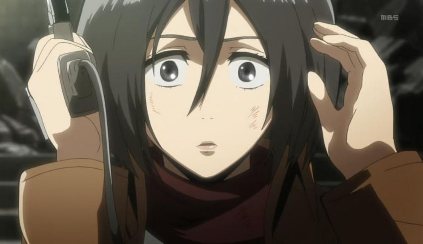 A girl with long black hair is holding a cell phone.