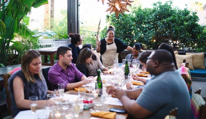 A group of people sitting around a table at an outdoor restaurant.