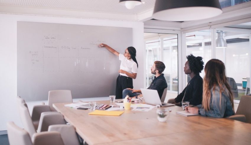 A group of people sitting around a table in a conference room.