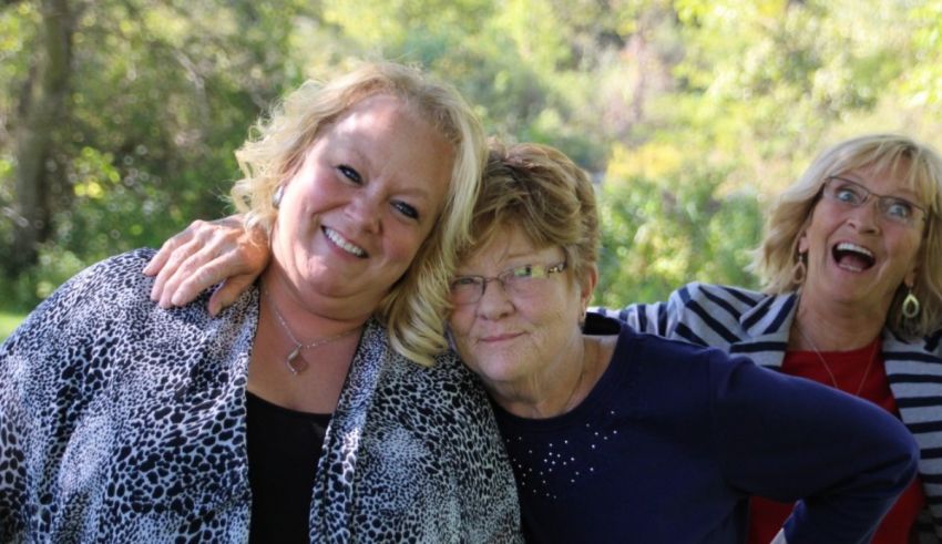 Three older women posing for a photo.