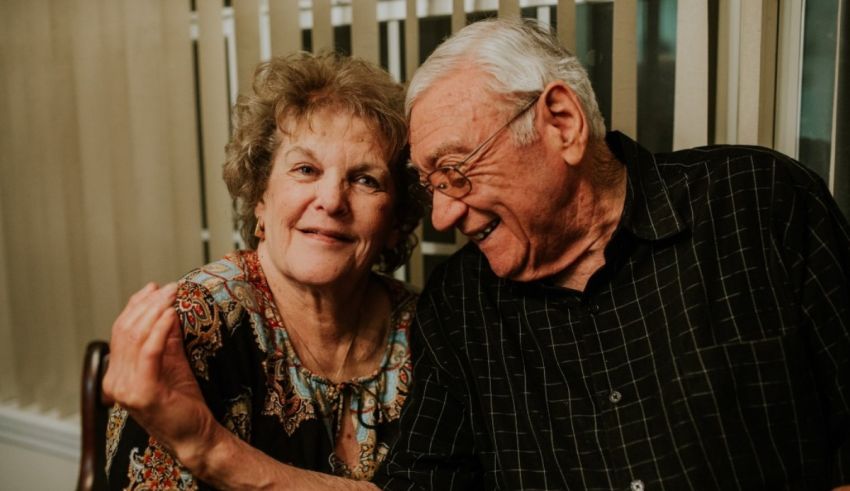 An older couple smiling at each other.
