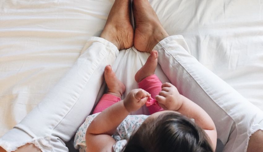 A baby's feet on a white bed.