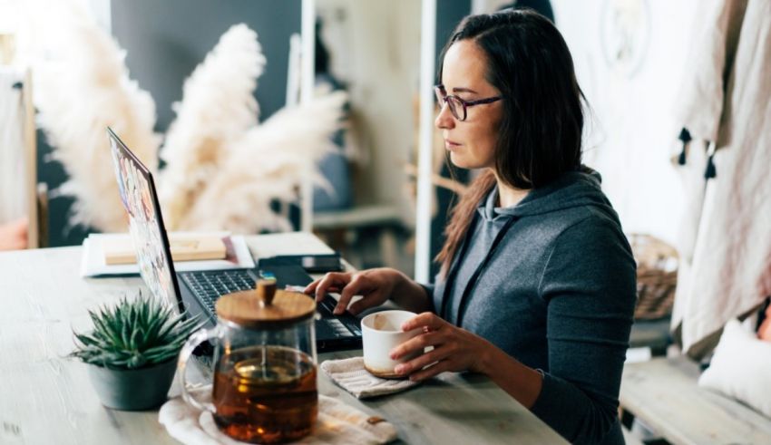 A woman working on her laptop at home.