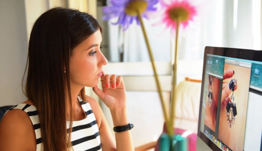 A woman looking at her computer screen.