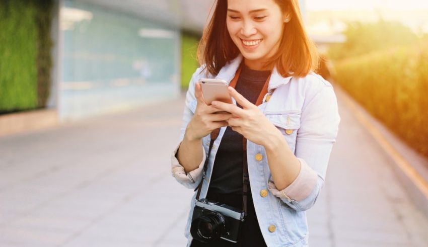 A young woman is looking at her cell phone.