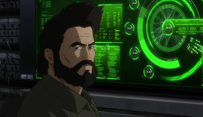A man with a beard in front of a green screen.