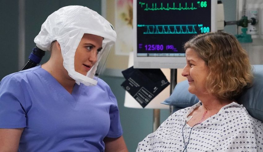 A woman in a hospital bed with a mask on her head.