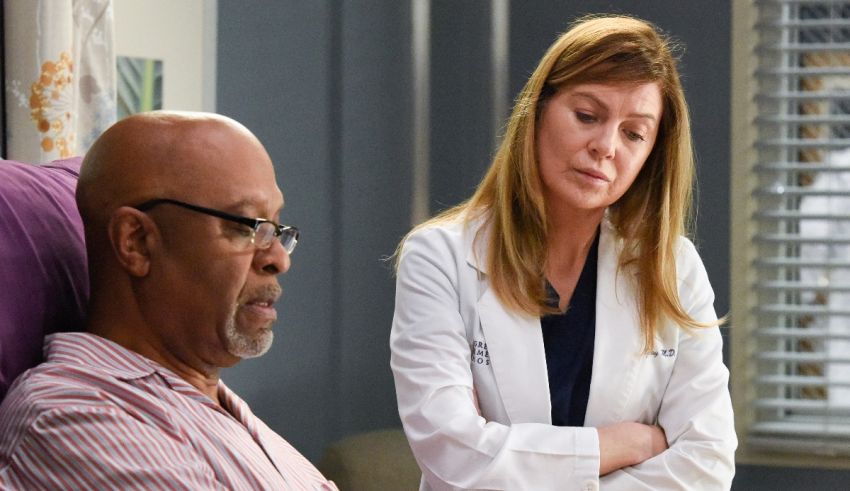 A man in a hospital bed next to a woman in a lab coat.