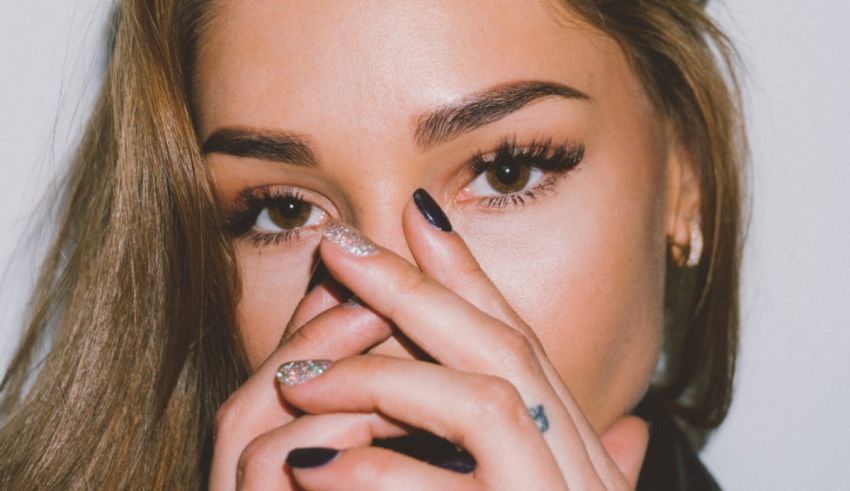 A woman covering her face with her hands.