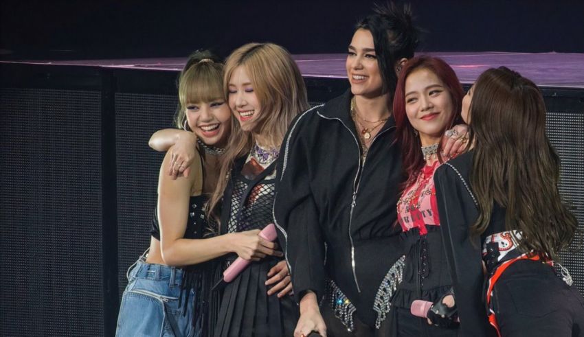 A group of girls posing for a picture on stage.