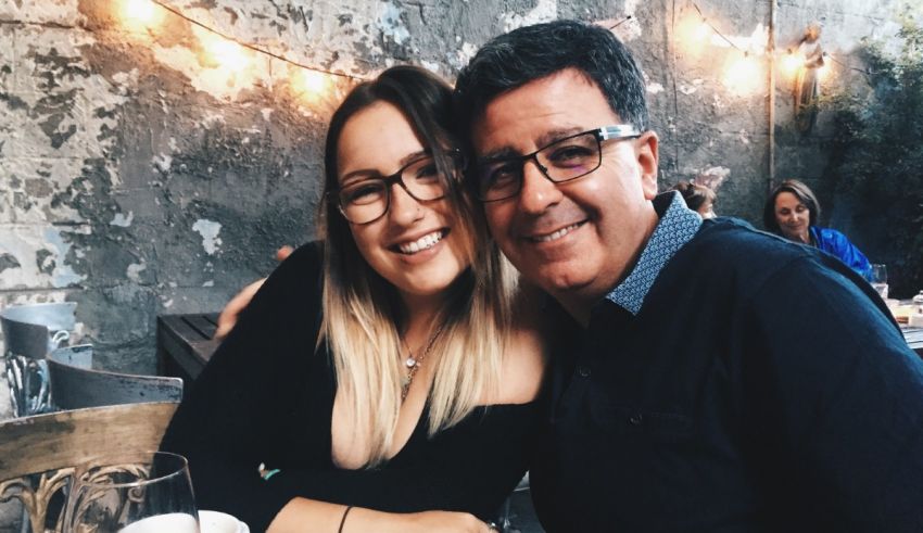 A man and woman posing for a photo at a restaurant.