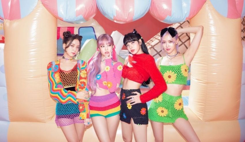 Four girls in colorful outfits posing for a photo.