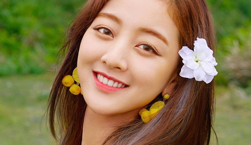 A young asian woman smiling with a flower in her hair.