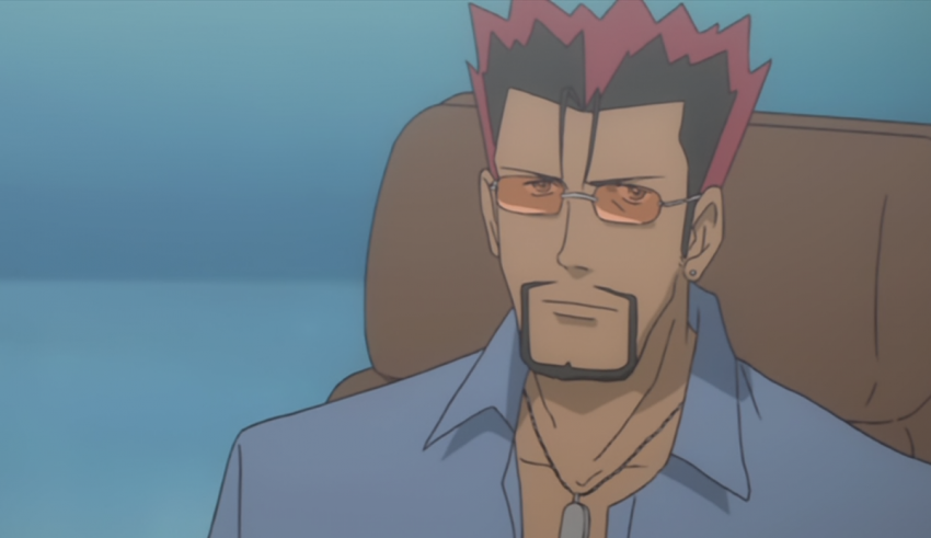 A man with red hair sitting in a chair.