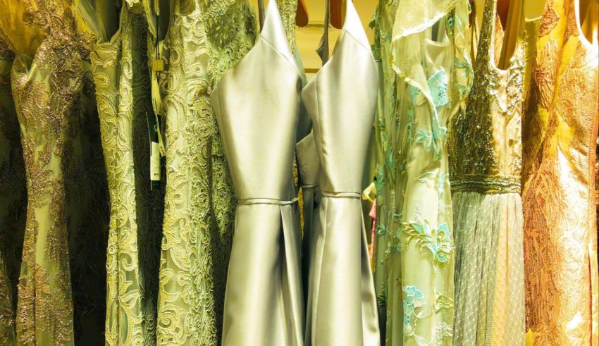 A row of dresses hanging on a rack.