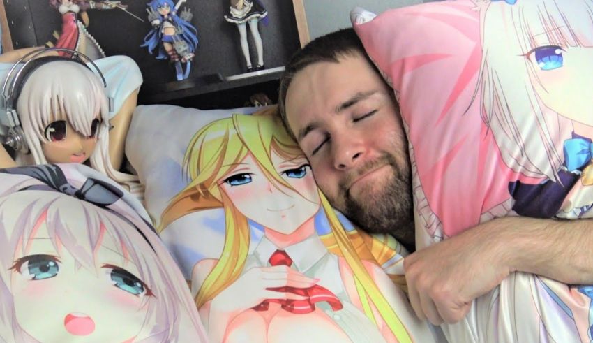 A man sleeping on a pillow with anime characters on it.