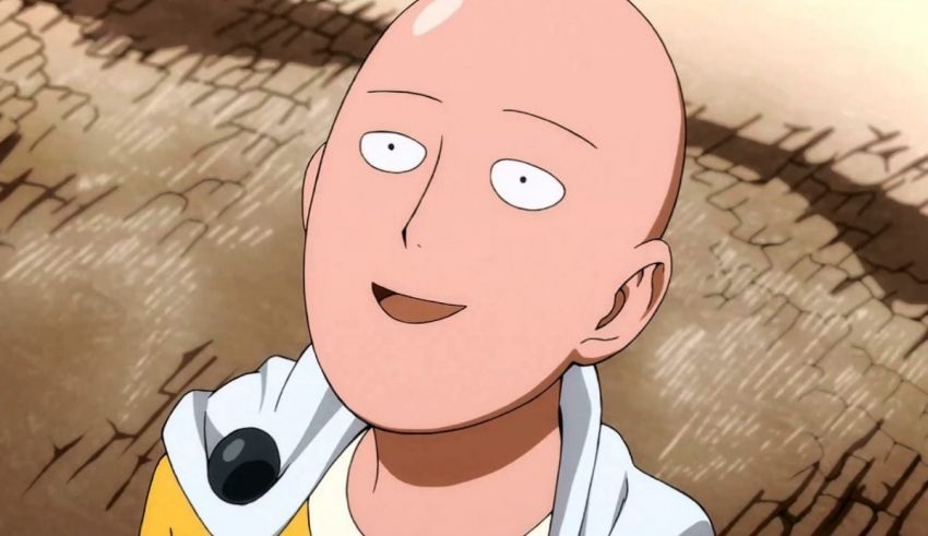 A bald man in a yellow shirt is looking at the camera.