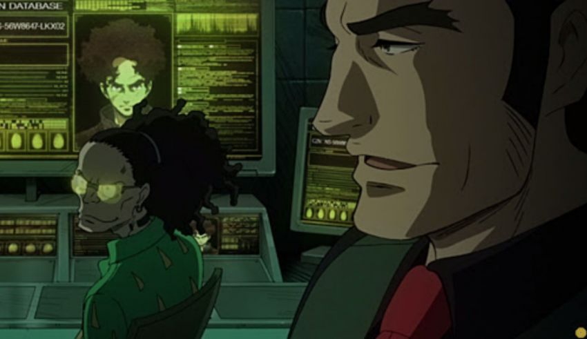 A man and a woman in front of a computer screen.
