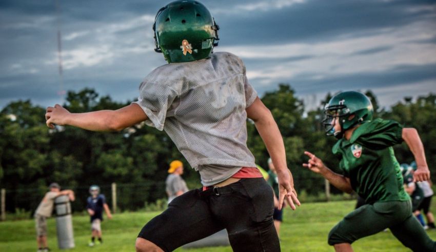 A football player catches a ball during a practice.