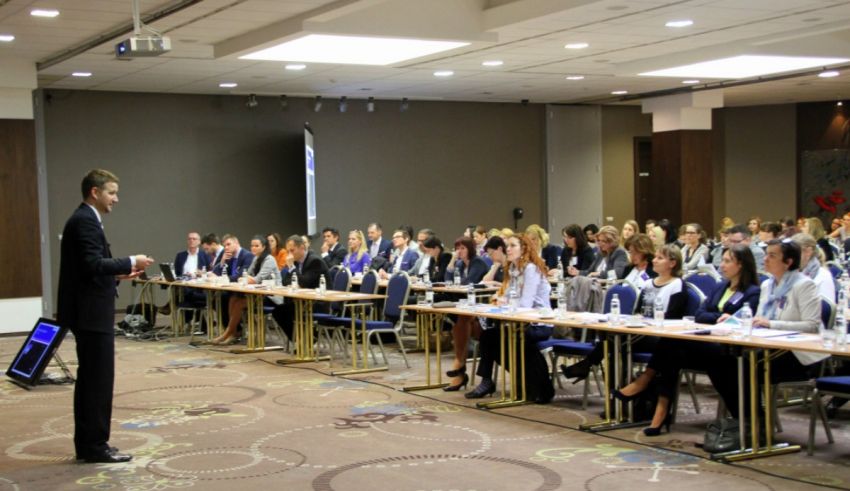 A group of people sitting in a conference room.